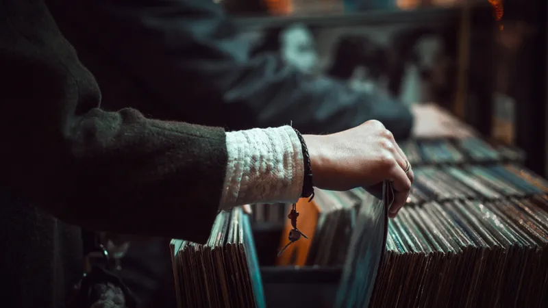 A person with looking through a large catalog of records.