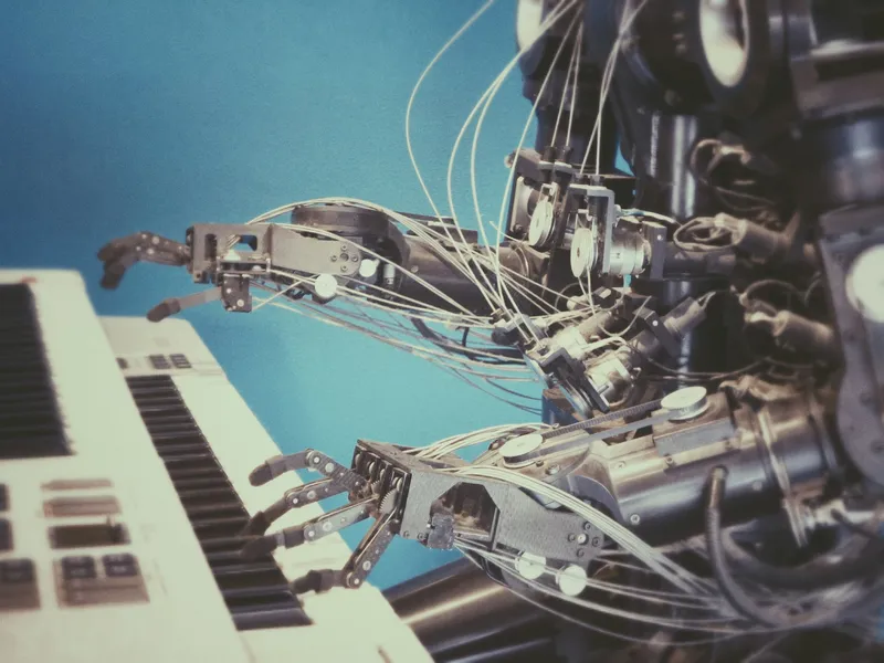 Photograph of a robot playing the piano.