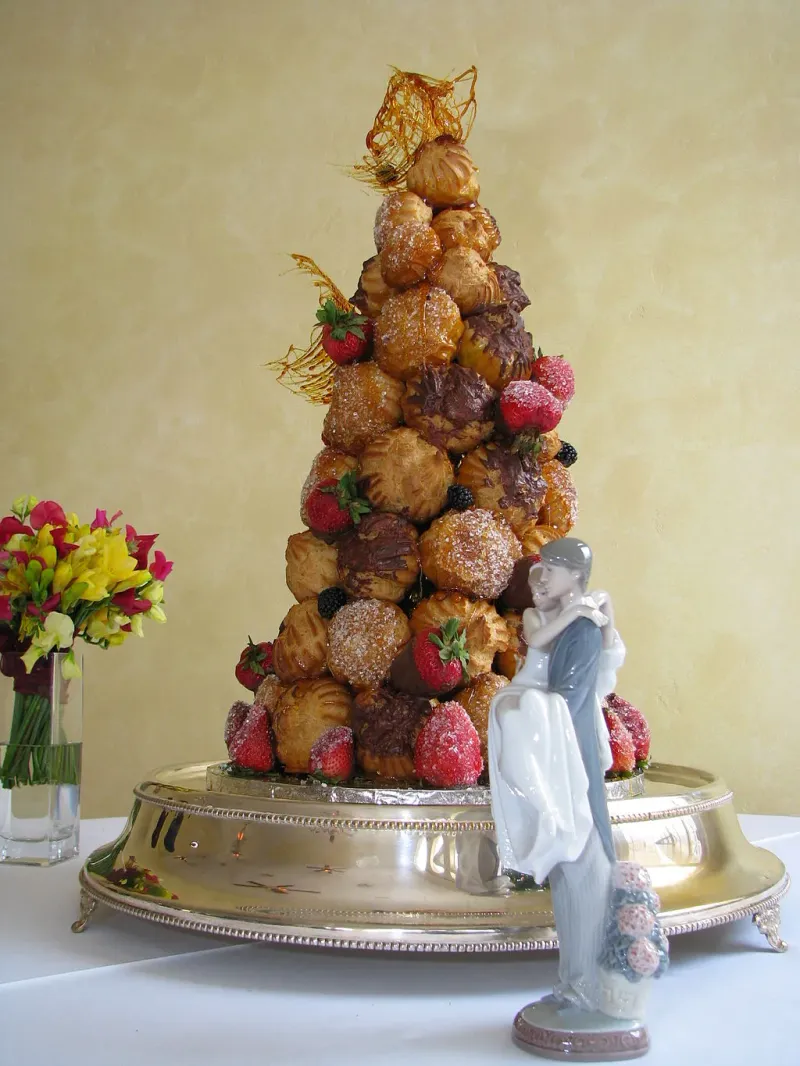 A cake made of a conical pile of round pastries.